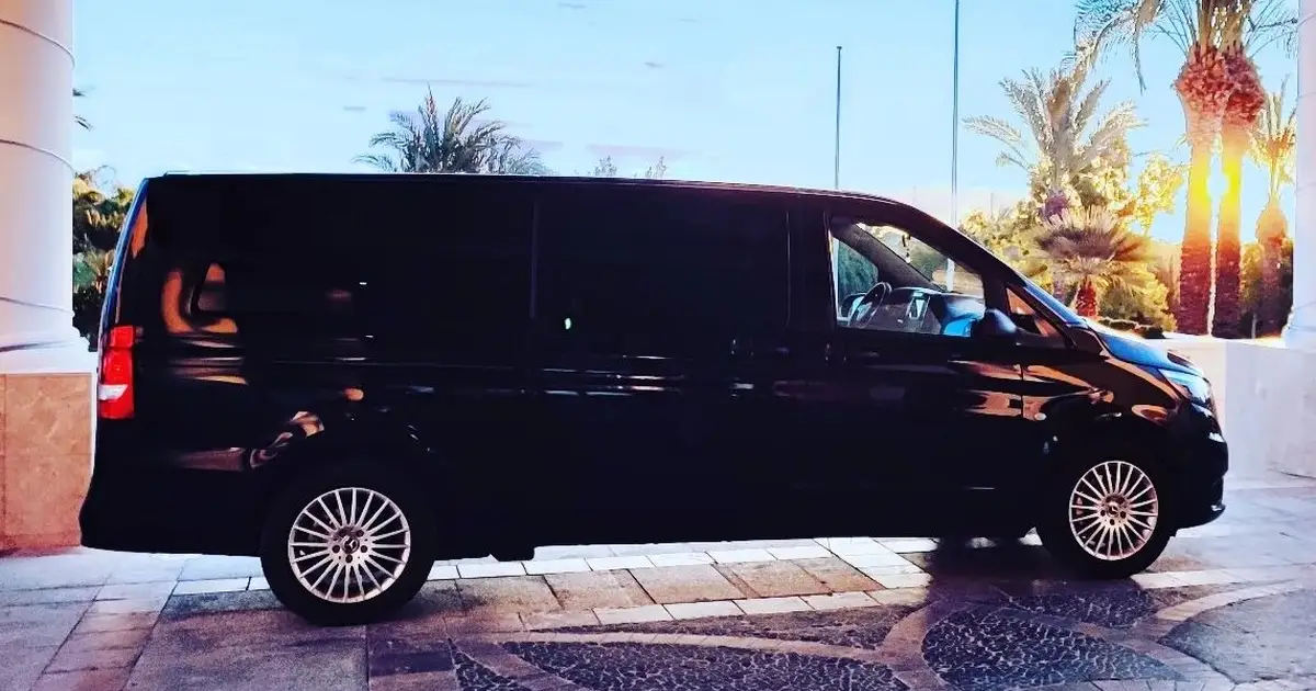 A 12 seater minibus Mercedes Sprinter waiting for passengers at a hotel parking in Murcia