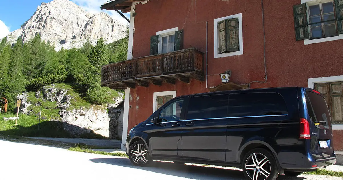 A 15 seater Mercedes Sprinter minibus parked at street in Trento