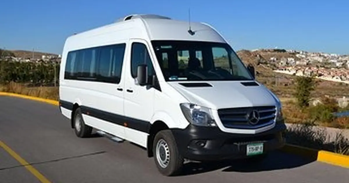 A 16 minibus Mercedes Sprinter parked on the road in Cuenca