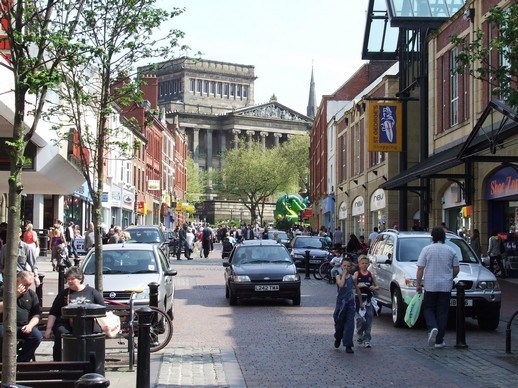 Friargate in Preston with its shops, pubs and people walking around